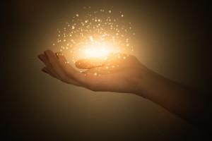 magic particles on the palms of a woman, a stream of magical energy emanating from female hands
